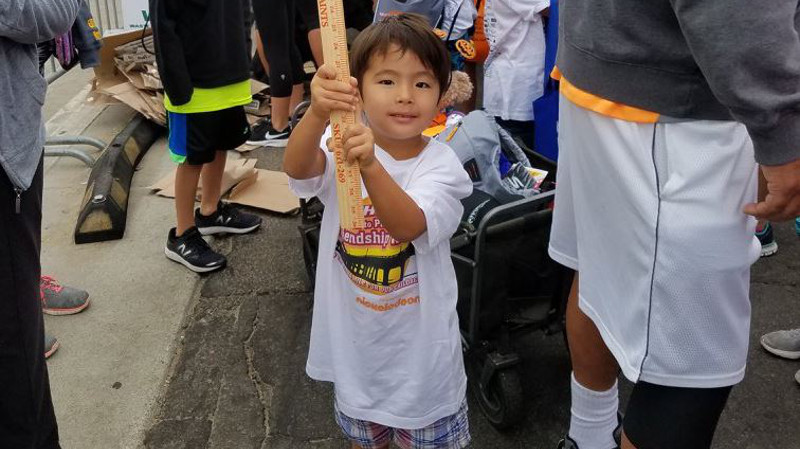 Boy holding TEF sign at the 2017 Skechers Walk.